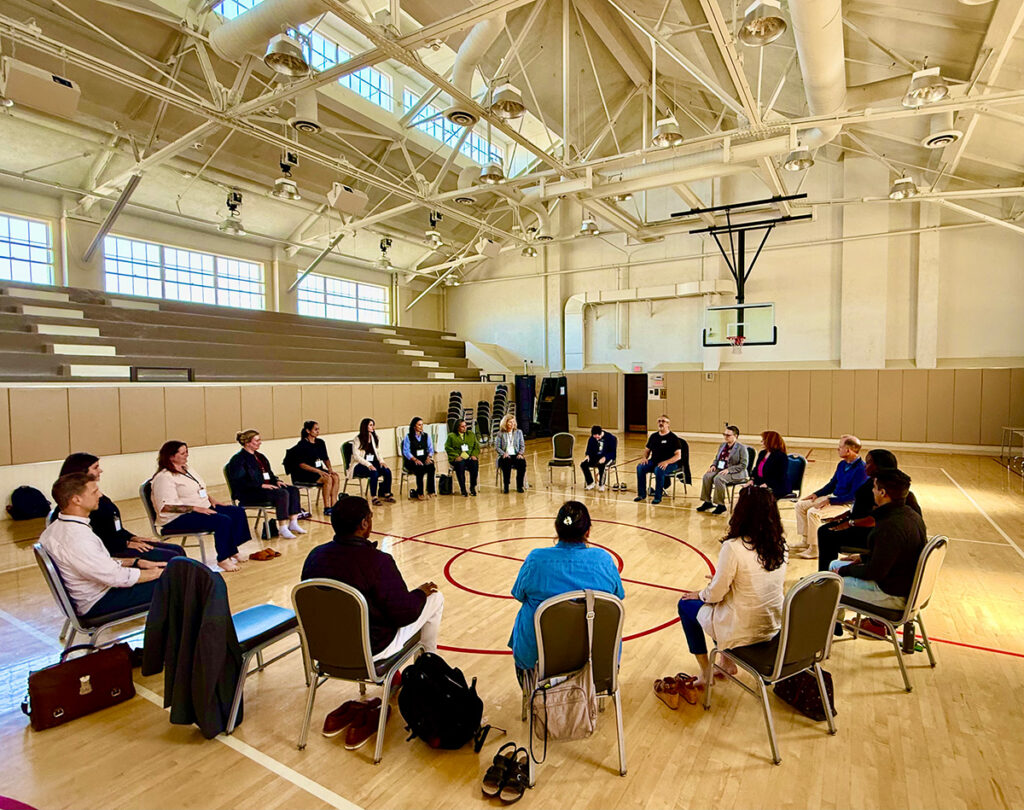 Bill Brown, Prison Yoga Project Director of Programming, Publishing & Advocacy, leads a yoga demonstration at the LA Veterans Treatment Court Symposium in the 10th-floor gymnasium of the Bob Hope Patriotic Hall.